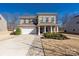 Charming two-story brick home with attached garage and inviting front porch at 16110 Foreleigh Rd, Huntersville, NC 28078