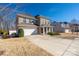 Two story home with a brick facade, attached garage, and well manicured lawn at 16110 Foreleigh Rd, Huntersville, NC 28078