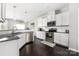 Bright kitchen featuring white cabinetry, granite countertops, stainless steel appliances, and dark hardwood flooring at 16110 Foreleigh Rd, Huntersville, NC 28078