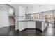 Kitchen featuring white cabinetry, granite countertops, stainless steel appliances, and dark hardwood flooring at 16110 Foreleigh Rd, Huntersville, NC 28078