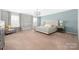 Spacious main bedroom with large windows, carpet flooring and a tufted headboard at 16110 Foreleigh Rd, Huntersville, NC 28078