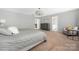 Carpeted main bedroom with en-suite bathroom, sitting area, dresser, and natural lighting at 16110 Foreleigh Rd, Huntersville, NC 28078