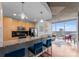 Bright open kitchen and living area with modern appliances, island with seating and expansive city views at 210 N Church St # 2409, Charlotte, NC 28202