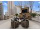 Stylish outdoor space features a cozy stone fireplace, TV, grill and comfortable seating with city views at 210 N Church St # 2409, Charlotte, NC 28202