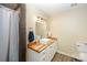 Modern bathroom with a wood countertop vanity, white vessel sink, and a tiled shower at 223 Scottish Dr, Mooresville, NC 28115