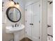 Bathroom featuring pedestal sink with dark fixtures and tile shower at 223 Scottish Dr, Mooresville, NC 28115