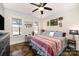Bright bedroom with a decorative quilt bed, modern ceiling fan, and hardwood floors at 223 Scottish Dr, Mooresville, NC 28115