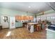 Large craft room with storage cabinets, wooden floors, and a roll-up garage door at 223 Scottish Dr, Mooresville, NC 28115