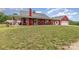 Inviting red farmhouse with covered porch and ample yard space at 223 Scottish Dr, Mooresville, NC 28115