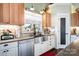 Charming kitchen featuring a farmhouse sink, granite countertops, and stainless steel dishwasher at 223 Scottish Dr, Mooresville, NC 28115