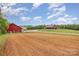 Farmland view with red farmhouse, barns and fertile soil at 223 Scottish Dr, Mooresville, NC 28115
