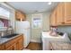 Bright laundry room with a washer and dryer, ample countertop space, and overhead cabinets at 223 Scottish Dr, Mooresville, NC 28115
