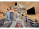 Cozy living space featuring wood paneling, a loft area, a fireplace, and an entertainment center at 223 Scottish Dr, Mooresville, NC 28115