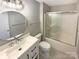 Bathroom featuring a single sink vanity, a glass shower door, and patterned floors at 2702 Occaneechi Ct, Waxhaw, NC 28173