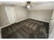 Bright bedroom featuring neutral carpet, ceiling fan, and white trim at 2702 Occaneechi Ct, Waxhaw, NC 28173