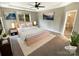 Stylishly staged main bedroom with neutral colors and a view to the outdoors at 2702 Occaneechi Ct, Waxhaw, NC 28173