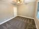 Neutral bedroom featuring carpeting, one window, and white trim at 2702 Occaneechi Ct, Waxhaw, NC 28173