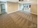 Bonus room with neutral carpeting, three windows, and a ceiling fan at 2702 Occaneechi Ct, Waxhaw, NC 28173