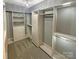 Walk-in closet with custom shelving and hanging racks, and gray walls at 2702 Occaneechi Ct, Waxhaw, NC 28173