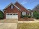 Attractive brick home with a well-kept lawn, two-car garage, and classic design at 2702 Occaneechi Ct, Waxhaw, NC 28173