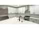 Modern kitchen with stainless steel appliances, white cabinets, and a spacious countertop at 2702 Occaneechi Ct, Waxhaw, NC 28173