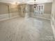 Bright living room with marble tile floors, modern light fixtures, and paneled walls at 2702 Occaneechi Ct, Waxhaw, NC 28173