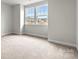 Light-filled bedroom with soft carpet, neutral walls, and double windows with neighborhood views at 3017 Tramore Dr, Harrisburg, NC 28075