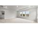 Spacious main bedroom featuring soft carpet, neutral paint, and a tray ceiling at 3017 Tramore Dr, Harrisburg, NC 28075