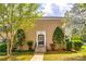 Charming tan brick townhome features a welcoming front door and beautiful landscaping at 315 Wakefield Dr, Charlotte, NC 28209