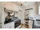 Well-maintained kitchen with white appliances, black countertops, and ample storage space at 315 Wakefield Dr, Charlotte, NC 28209