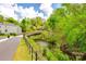 Scenic walking path through the neighborhood following along a stream and lush trees at 315 Wakefield Dr, Charlotte, NC 28209