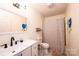 Charming bathroom featuring updated vanity, toilet and shower with patterned curtain at 3415 23Rd Ne St, Hickory, NC 28601