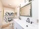 Bathroom with double sinks, a large mirror, and a shower with a butterfly curtain at 3415 23Rd Ne St, Hickory, NC 28601