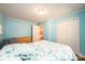 Bedroom with blue walls, wood-look floors, dresser, double door closet and double bed at 3415 23Rd Ne St, Hickory, NC 28601