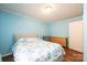 Bright bedroom with blue walls, hardwood floors, large window, and patterned bedspread at 3415 23Rd Ne St, Hickory, NC 28601