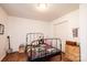 Bedroom featuring a metal frame bed, wood-look floors and a bright window at 3415 23Rd Ne St, Hickory, NC 28601