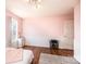 Bright bedroom with pink walls, wood floors, beadboard and a large window at 3415 23Rd Ne St, Hickory, NC 28601