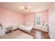 Bright bedroom with pink walls, wood floors, beadboard and a large window at 3415 23Rd Ne St, Hickory, NC 28601