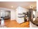 Well-lit kitchen with white cabinets, stainless steel appliances, dark countertops, and hardwood floors at 3415 23Rd Ne St, Hickory, NC 28601
