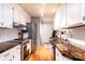 Well-lit kitchen featuring stainless steel appliances, dark countertops, and ample cabinet space at 3415 23Rd Ne St, Hickory, NC 28601