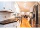 Galley kitchen with white cabinets, dark countertops, stainless steel appliances, and subway tile backsplash at 3415 23Rd Street Ne St, Hickory, NC 28601