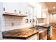 Updated kitchen featuring white cabinets, dark countertops, subway tile backsplash, and stainless steel sink at 3415 23Rd Street Ne St, Hickory, NC 28601