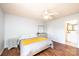 Spacious main bedroom with a ceiling fan, wood floors, and a view into an ensuite bathroom at 3415 23Rd Ne St, Hickory, NC 28601