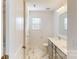 Clean bathroom with marble tile flooring, double sink vanity, and natural light from a window at 4005 Lawnview Dr, Charlotte, NC 28269