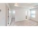 Bright bedroom with neutral carpet, walk-in closet and tray ceiling with recessed lights at 4005 Lawnview Dr, Charlotte, NC 28269
