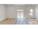Bright living room features light wood flooring and sliding glass door at 4005 Lawnview Dr, Charlotte, NC 28269