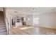 Open-concept living room with a view of the kitchen, stairs, and light wood flooring at 4005 Lawnview Dr, Charlotte, NC 28269