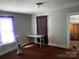 Cozy bedroom with a table under the window, carpet floors, and closet space at 441 Hope St, Rock Hill, SC 29730