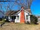 Charming bungalow with a brick chimney and a cozy front porch under a clear blue sky at 441 Hope St, Rock Hill, SC 29730