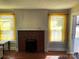 Cozy living room features a brick fireplace and sunny windows, creating a warm atmosphere at 441 Hope St, Rock Hill, SC 29730
